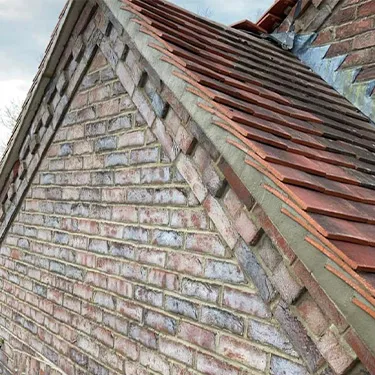 a brick building with a red tiled roof