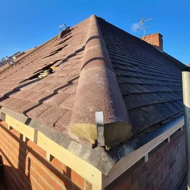 a roof with a brick chimney on top of it