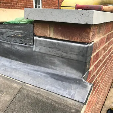 a close up of a metal gutter on the side of a building